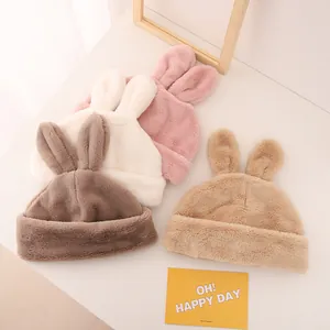 Close-up of four colors of plush rabbit ear winter hats with soft warm lining for kids