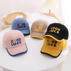 Detail of warm lamb wool baseball caps for kids with GOOD LUCK embroidery and contrast piping