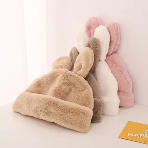 Detail showing plush bunny ear beanies in beige, brown, white and pink soft textures