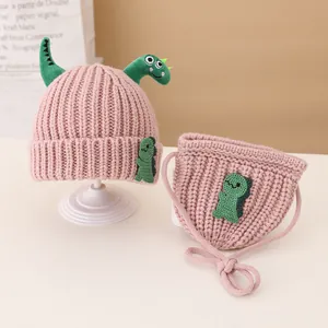Pink knit hat and matching crossbody bag set with green 3D dinosaur accents for kids