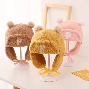 Plush baby winter hats with P letter embroidery and double pompoms in soft teddy fleece
