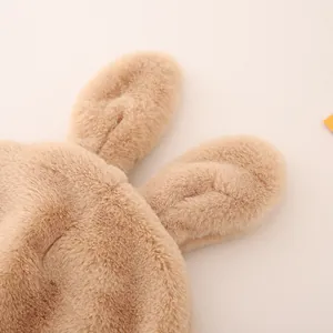 Detail of plush rabbit ears on khaki winter hat showing soft texture and fine stitching