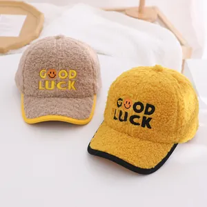 Close-up of fluffy sherpa baseball caps with GOOD LUCK embroidery and smiling face