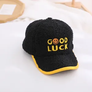 Detailed view of Good Luck embroidery on plush warm baseball cap for kids