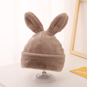 Close-up of soft faux fur winter hat with long rabbit ears in light brown on display