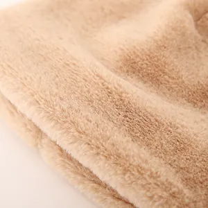 Close-up of thick beige faux cashmere plush lining for winter warm children hat