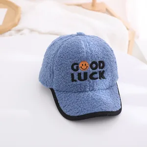 Detailed macro view of the blue lamb wool baseball cap with GOOD LUCK embroidery and smile