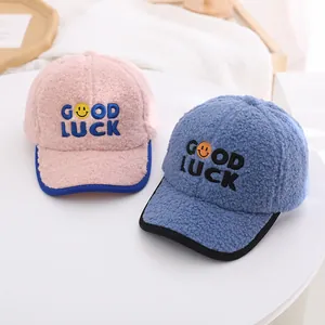 Plush winter baseball caps for kids with Good Luck embroidery and smiley face detail