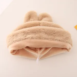 Close-up of soft khaki plush rabbit ears and warm fleece lining on toddler winter hat