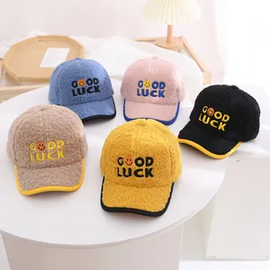 Detail of five fleece baseball caps with GOOD LUCK embroidery and smiling face patch