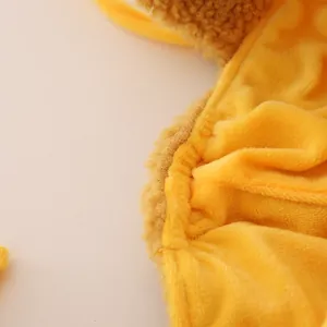 Detail of yellow plush thermal hat featuring thick faux fur texture and neat stitching