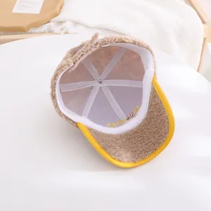 Detail of warm beige sherpa baseball cap showing white breathable mesh lining and stitching