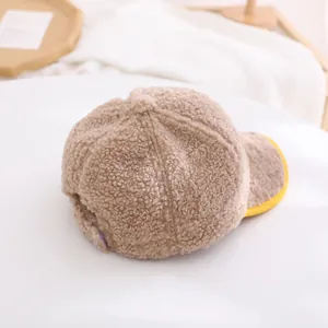 Detail of soft fleece baseball cap featuring warm texture and yellow contrast trim