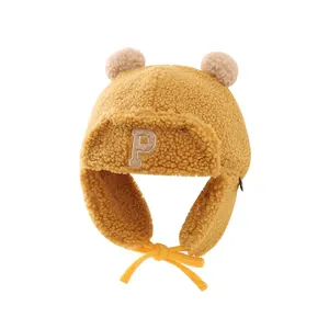 Ginger yellow kids aviator trapper hat with fuzzy earflaps and double pom-poms