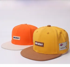 Detail view of two-tone flat brim kids baseball caps with giraffe patch and leather label