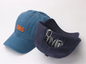 Close-up of 1985 embroidery and metal adjustable buckle on cotton baseball caps