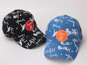 Detail of children's baseball caps featuring BABY graffiti and rubber Yeah patch