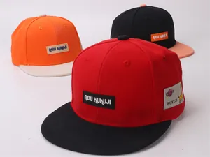Detail of color-blocked canvas hip-hop hats showing stitch quality and woven brand labels