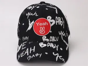Detail of black cotton baby baseball cap featuring graffiti print and a red logo patch