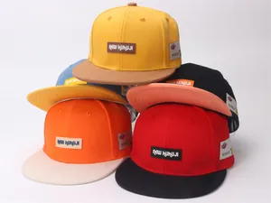 Detail of color-block snapback hats featuring leather NEW KUKUJI logo and heart side label