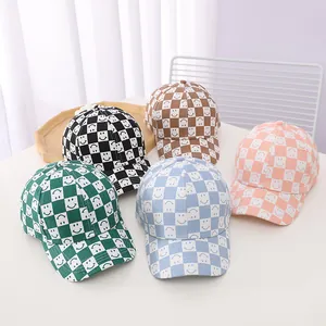 Detailed grid of baseball caps featuring checkered patterns and smiley faces in five colors