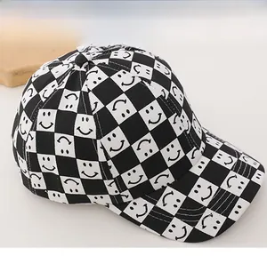 Detail of checkered kids baseball cap with smiley face pattern and six-panel cotton fabric