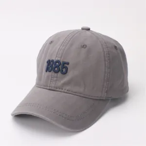 Detail shot of vintage dark grey washed cotton baseball cap with 1985 embroidery