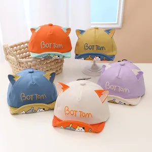 Detail view of cotton baby baseball caps with cat ears and cartoon animal prints in five colors
