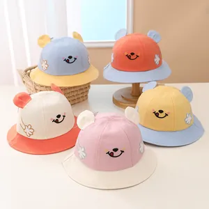 Detailed display of assorted baby sun hats with cute smile faces and 3D ears design