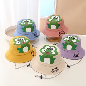 Detail of colorful frog bucket hats for kids with adjustable chin straps and embroidery