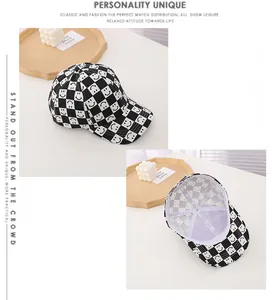 Detail of checkered baseball cap with smiley patterns and breathable inner lining