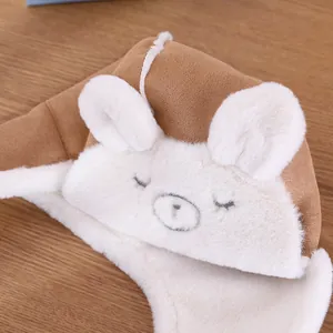 Dettaglio del cappello da aviatore per bambini con fodera in peluche e ricamo di orsetto