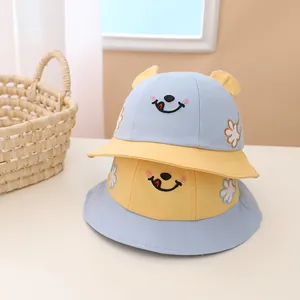 Kids cotton sun hats with smiley face embroidery and cute ears in blue and yellow colors