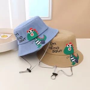 Sombreros de pescador infantiles en azul y caqui con dinosaurio y cordón ajustable