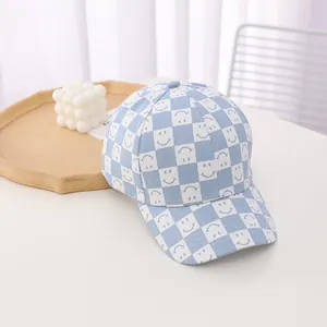 Detailed macro view of the light blue checkered smiley face pattern on cotton baseball cap