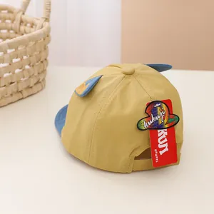 Detailed close-up of yellow and blue contrast baby baseball cap with adjustable strap back