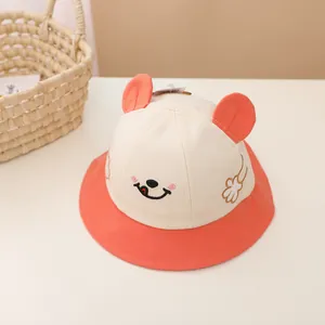 Detailed embroidery of cartoon smiley face and 3D ears on a cotton baby sun hat