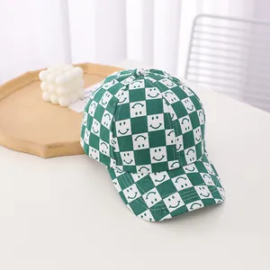Close-up of green and white checkerboard baseball cap with smile pattern on canvas material