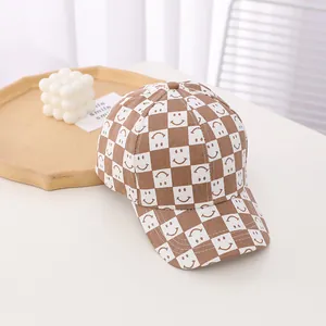 Close-up of checkerboard baseball cap with smile patterns on a minimalist tabletop