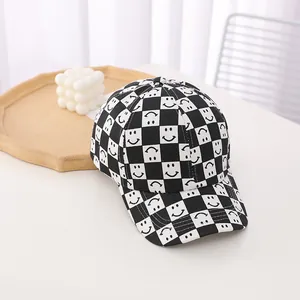 Detail of checkered baseball cap with smiley patterns on high-quality cotton canvas
