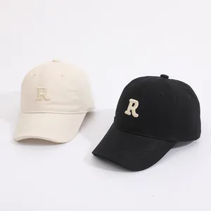 Close-up of baseball caps with 3D R letter embroidery and breathable cotton fabric