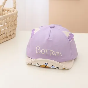 Detail of soft purple baby baseball cap with cute cat ears and embroidered letters
