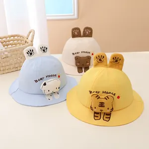 Close-up of cotton baby bucket hats with cute bear embroidery and 3D animal ears