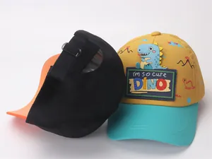 Detail of children baseball cap showing adjustable back strap and cartoon dinosaur patch