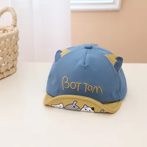 Detail of baby baseball cap with 3D cat ears and cartoon pattern on the brim
