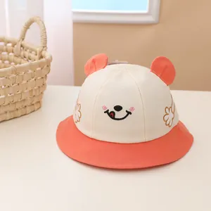 Detailed embroidery of smiley face and flowers on a cotton bucket hat for babies