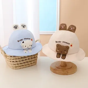 Detail showing the cartoon bear embroidery and 3D ears on a cotton kid's sun hat