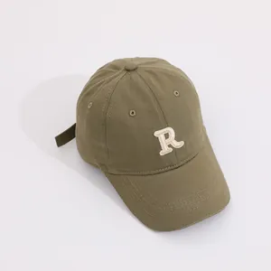 Detail view of army green cotton baseball cap with embroidered letter R and adjustable strap