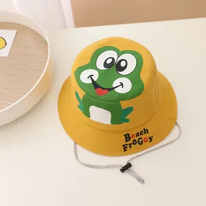 Detail of yellow cotton kids bucket hat with green frog pattern and windproof drawstring
