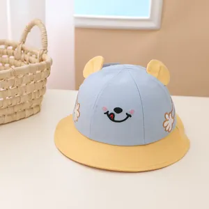 Detail of kids fisherman hat with 3D yellow ears and cute embroidered smiley face